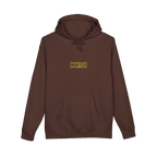 TRUST THE RUST chest badge on a brown hoodie