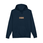 TRUST THE RUST chest badge on a navy hoodie