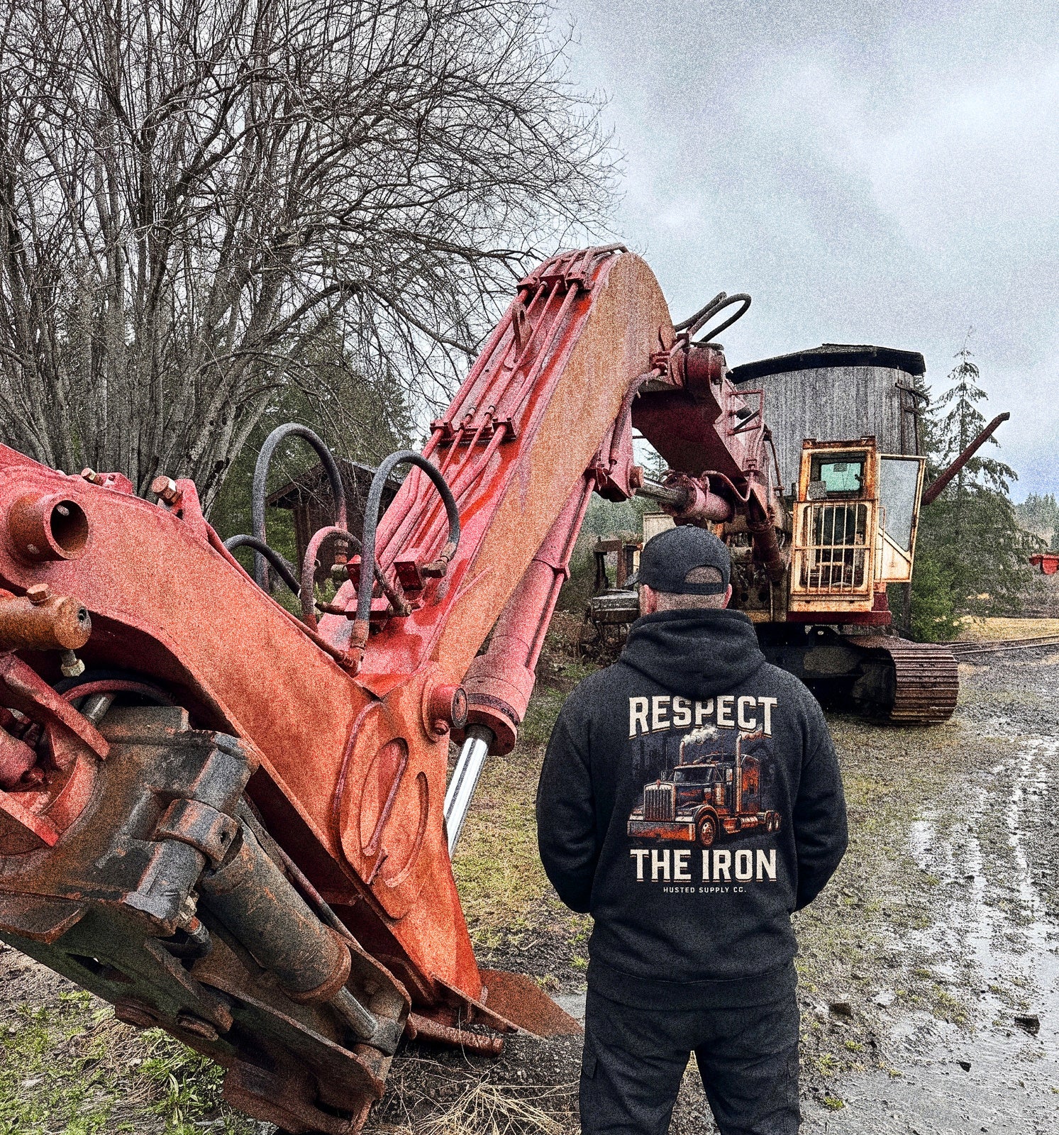 RESPECT THE IRON conventional semi hoodie worn by an operator on a jobsite