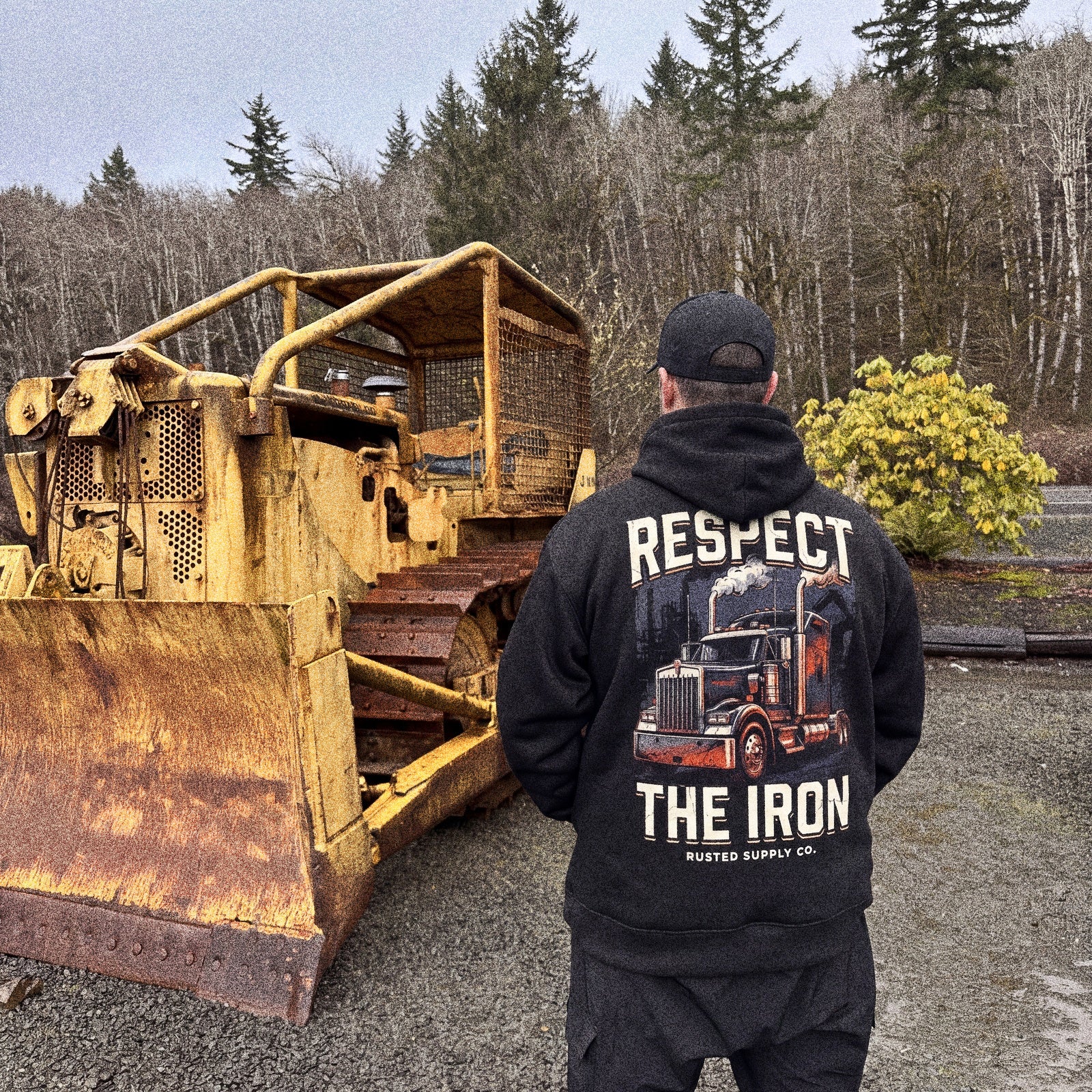 Operator in a RESPECT THE IRON hoodie beside a conventional semi